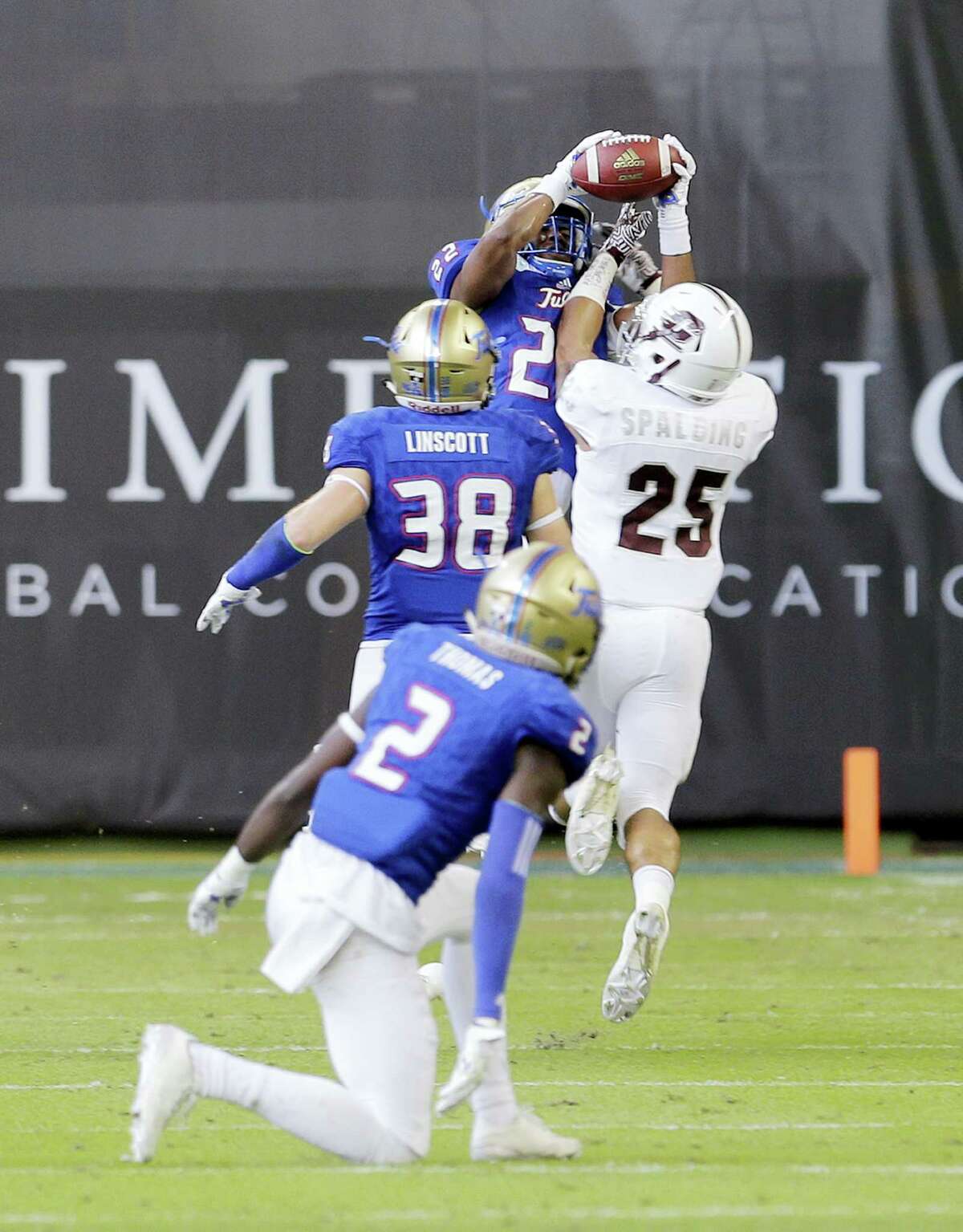 Tulsa safety Jeremy Brady (22) intercepts a pass intended for Central Michigan running back Devon Spalding (25) in the first half of the Miami Beach Bowl. Tulsa beat Central Michigan 55-10.