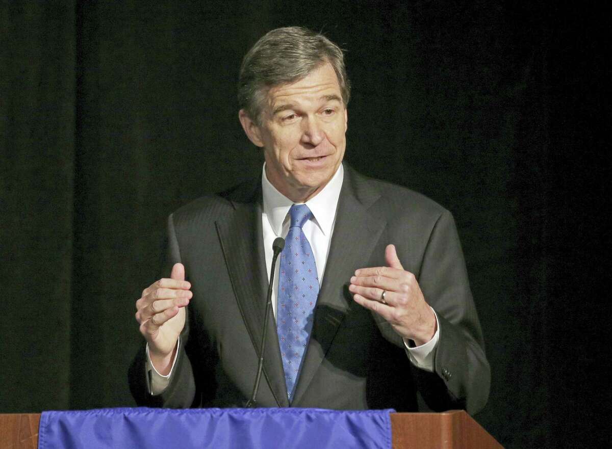 In this June 24, 2016 photo, then-North Carolina Attorney General Roy Cooper speaks during a forum in Charlotte, N.C. Roy, the state’s incoming governor, said Monday, Dec. 19, 2016 that North Carolina legislators will repeal the contentious HB2 law that limited protections for LGBT people and led to an economic backlash.