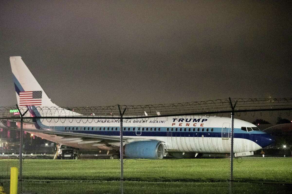 Republican vice presidential candidate Indiana Gov. Mike Pence’s campaign airplane sits partially on the tarmac and the grass after sliding off the runway while landing at LaGuardia airport, Thursday, Oct. 27, 2016, in New York.