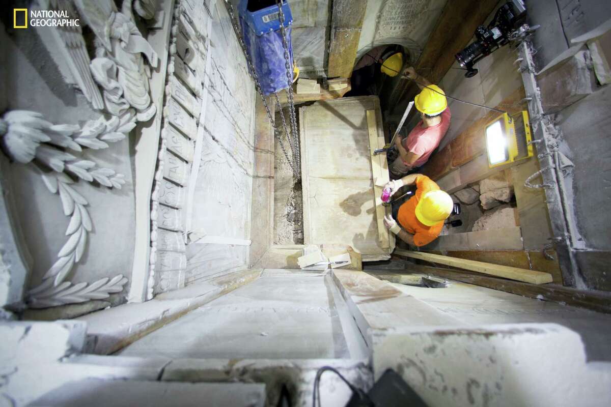 Workers remove the top marble layer of the tomb said to be of Jesus Christ, in the Church of Holy Sepulcher in Jerusalem. A restoration team has peeled away a marble layer for the first time in centuries in an effort to reach what it believes is the original rock surface where Jesus’ body was laid.