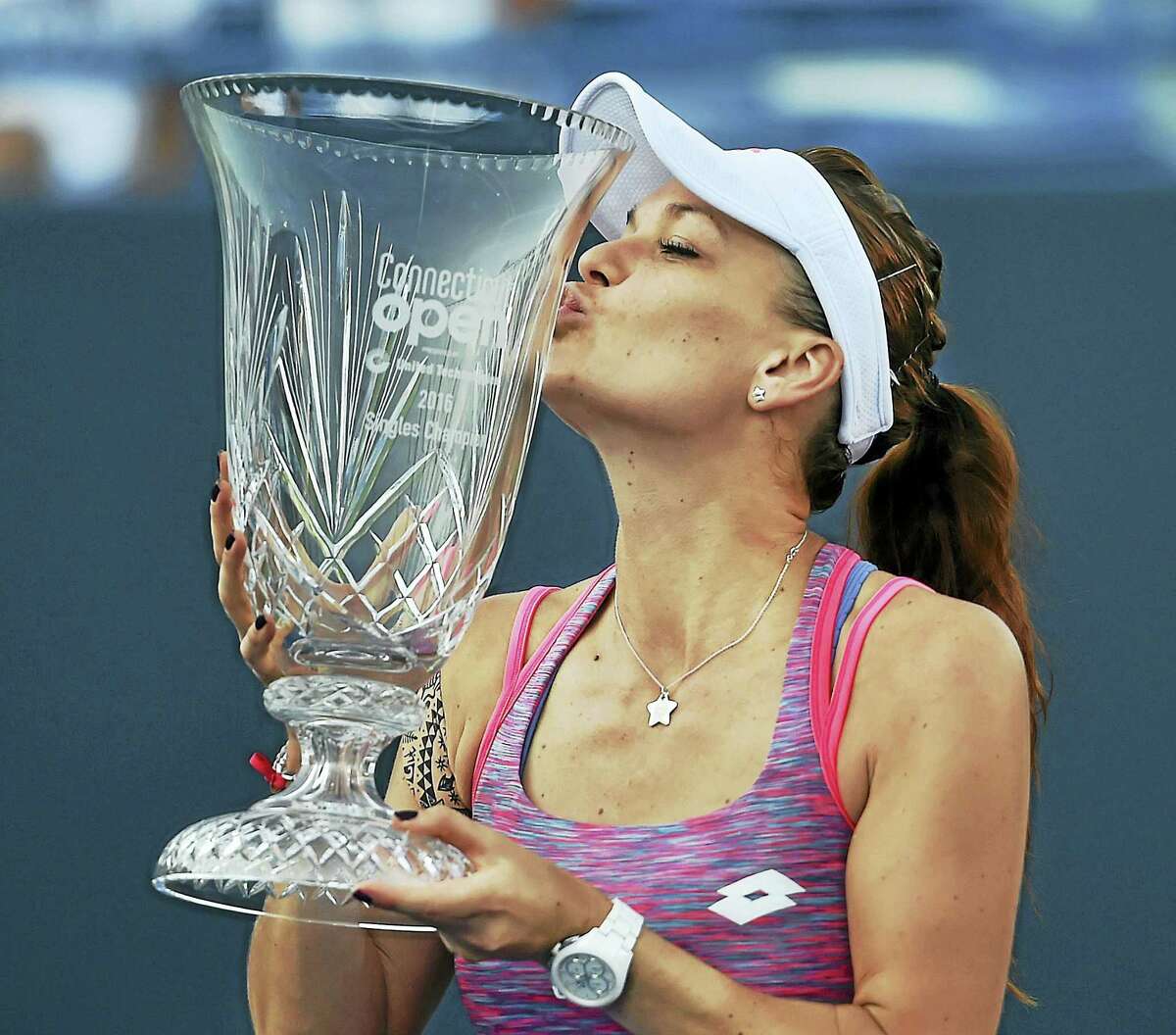 Agnieszka Radwanska kisses the trophy after defeating Elina Svitolina in the championship match at the Connecticut Open on Saturday.