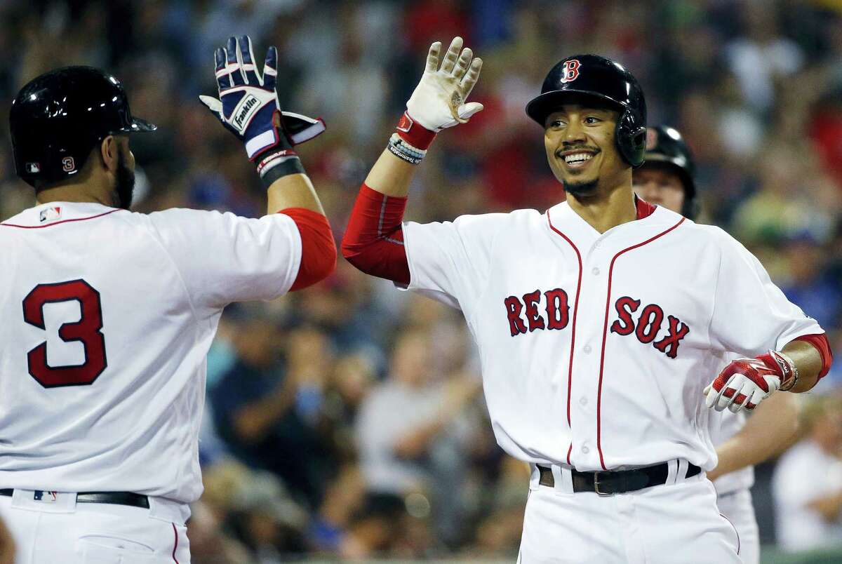 Mookie Betts, right, celebrates his solo home run with Sandy Leon during the fifth inning.