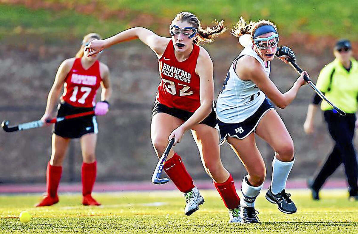 Branford midfielder Autumn McHenry and Lauralton Hall senior Madelyn Monahan battle for a loose ball Tuesday at the SCC semifinals in Milford. The Hornets won 4-1 in overtime.