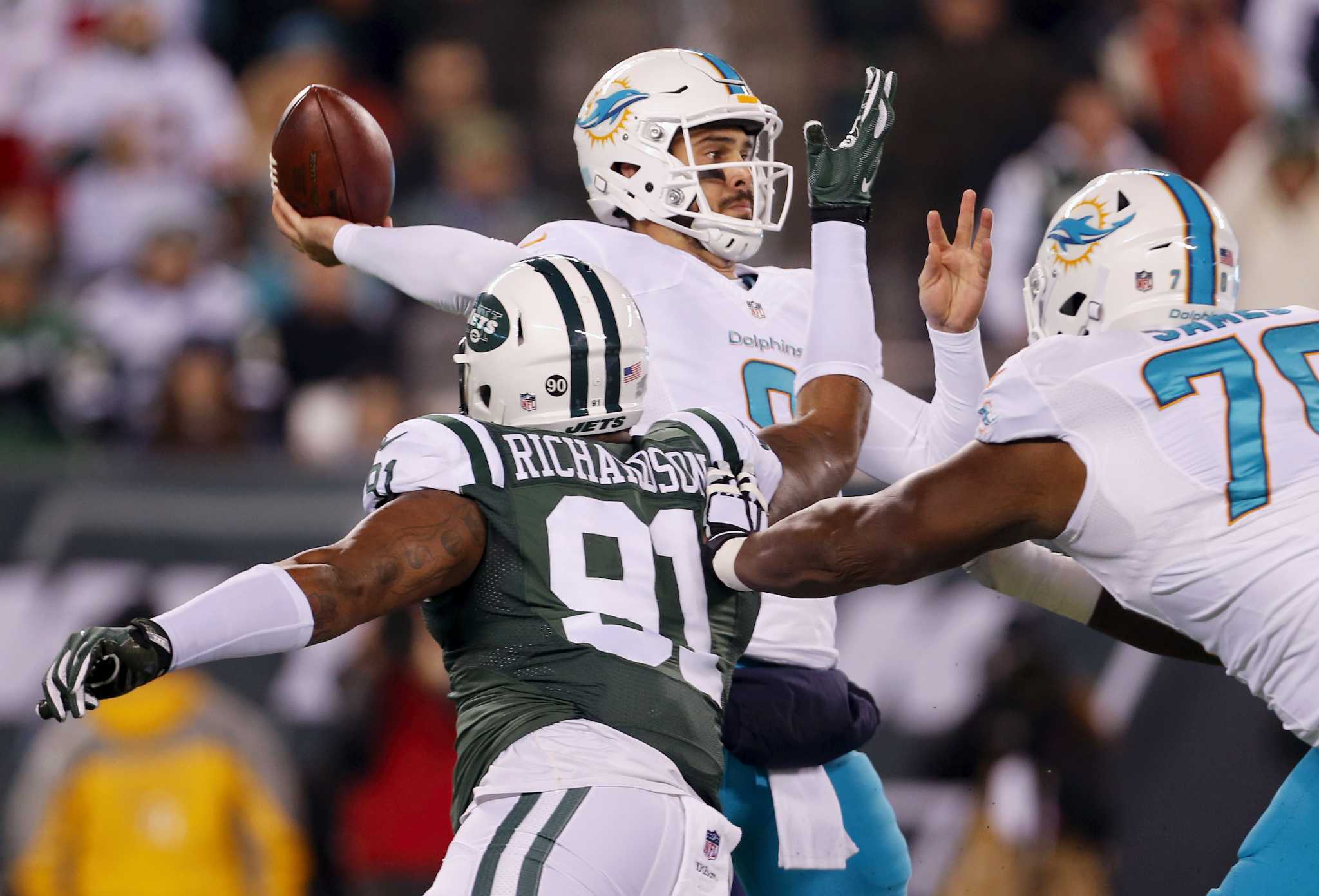 Miami Dolphins Matt Moore throws a pass in the fourth quarter against the  New York Jets in week 8 of the NFL season at MetLife Stadium in East  Rutherford, New Jersey on