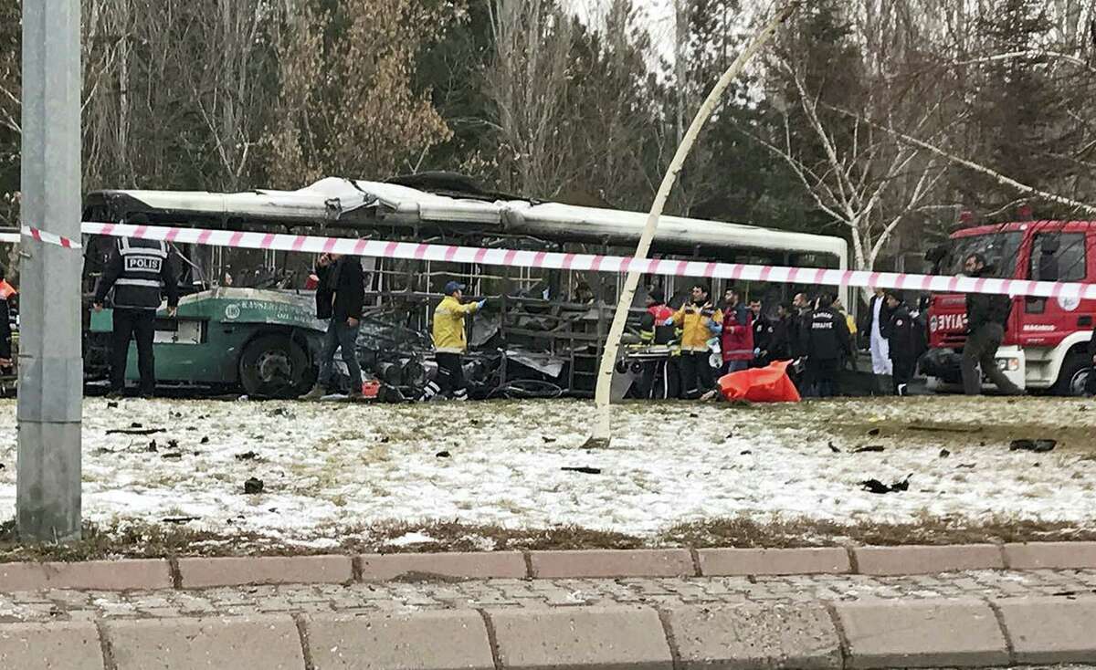 Rescue services members work at the scene of a car bomb attack in central Anatolian city of Kayseri, Turkey, Saturday, Dec. 17, 2016. A public bus was heavily damaged and dear and injured were reported. Turkish authorities have banned distribution of images relating to the Istanbul explosions within Turkey.
