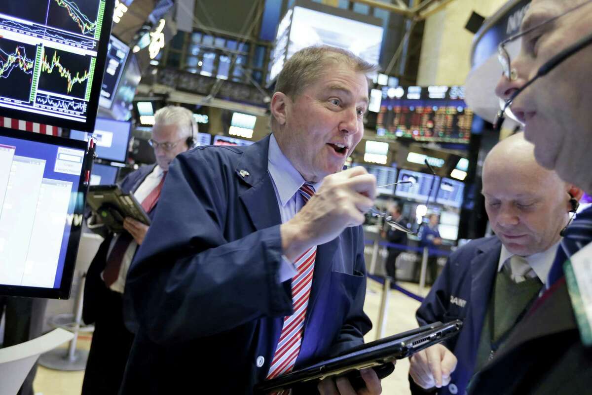 Trader David Williams, center, works on the floor of the New York Stock Exchange Wednesday.