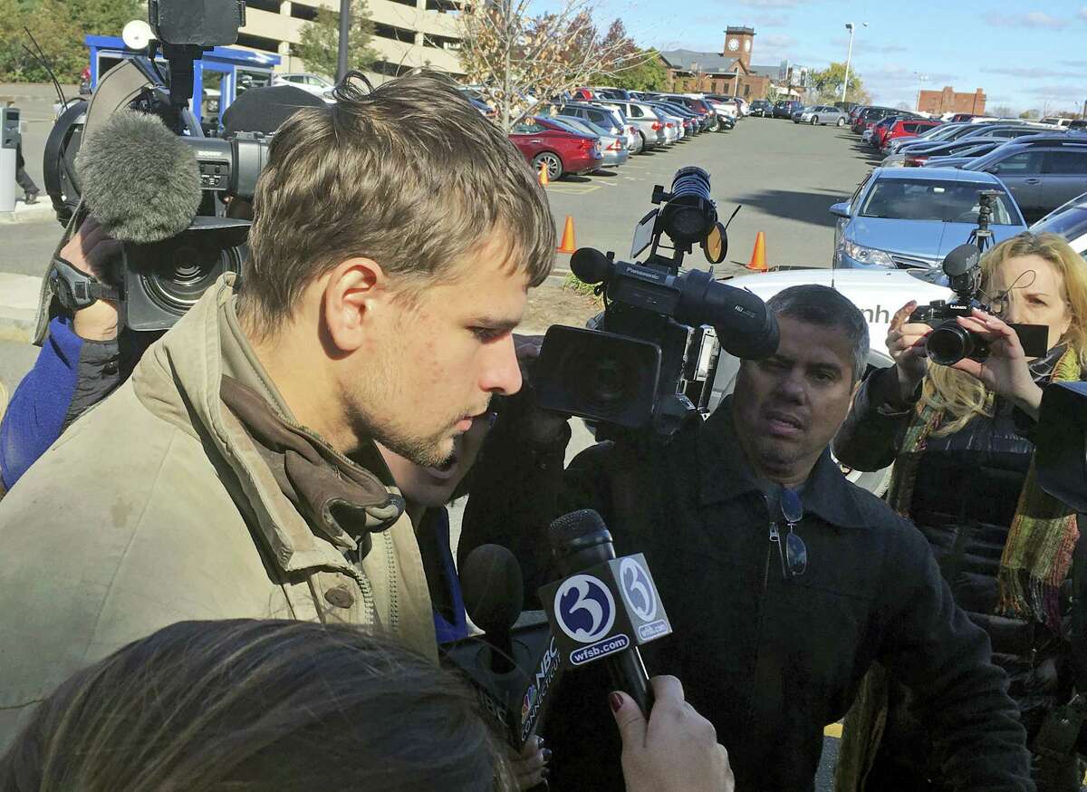 Nathan Carman, speaks to reporters outside Saint Patrick - Saint Anthony Church in Hartford, Conn., Wednesday after a memorial service for his mother, Linda Carman, who was lost at sea. Nathan Carman was rescued by a freighter about 100 miles off the coast of Martha’s Vineyard after the boat he and his mother were on sank during the weekend of Sept. 17.