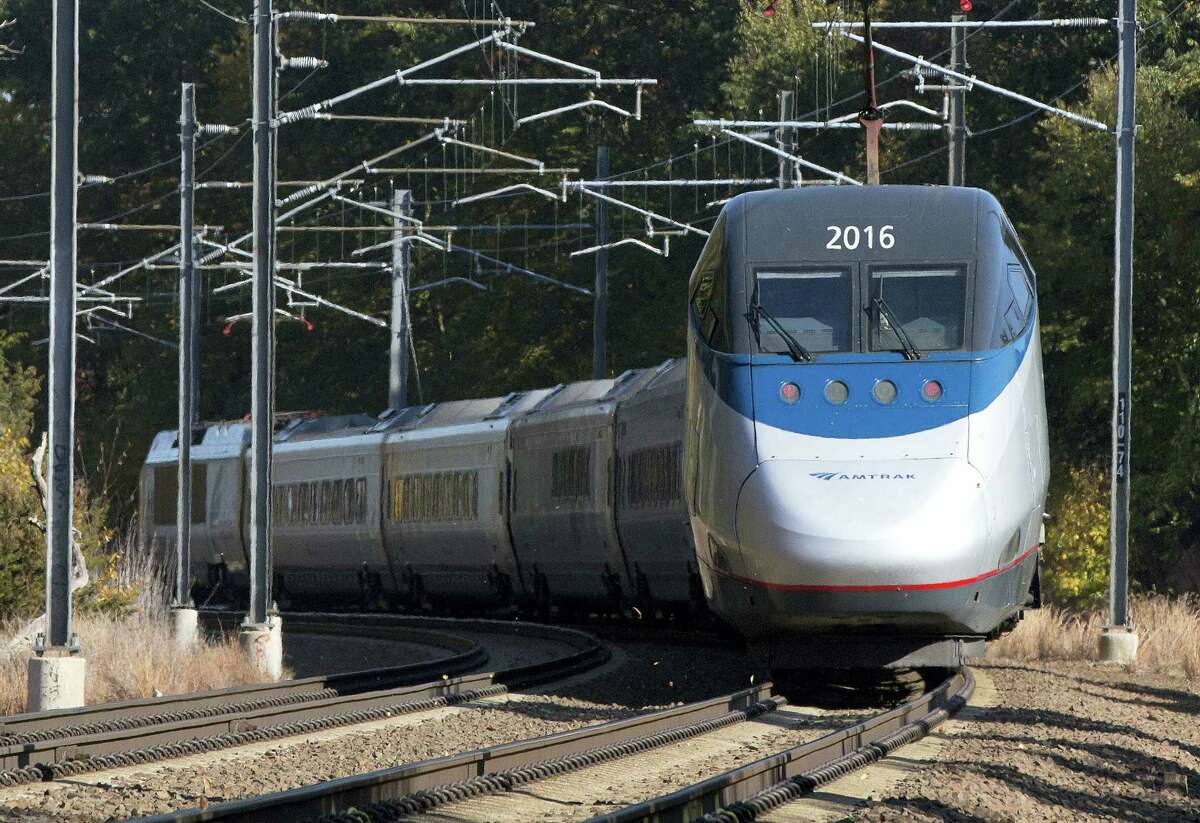 In this Oct. 18, 2016 photo, an Amtrak Acela train travels through Old Lyme, Conn. A plan to speed up Amtrak’s high-speed rail corridor from Boston to Washington, D.C., is welcomed by business commuters but finding its strongest opposition in some shoreline towns in Connecticut.