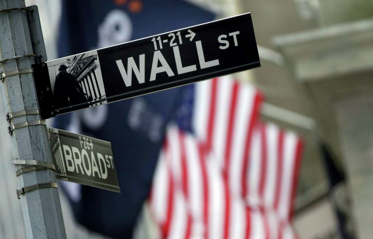 FILE - This Thursday, Oct. 2, 2014, file photo, shows a Wall Street sign adjacent to the New York Stock Exchange. Stocks rose in early trading Friday, Aug. 26, 2016, following two days of declines after Federal Reserve Chair Janet Yellen gave an upbeat assessment on the U.S. economy.