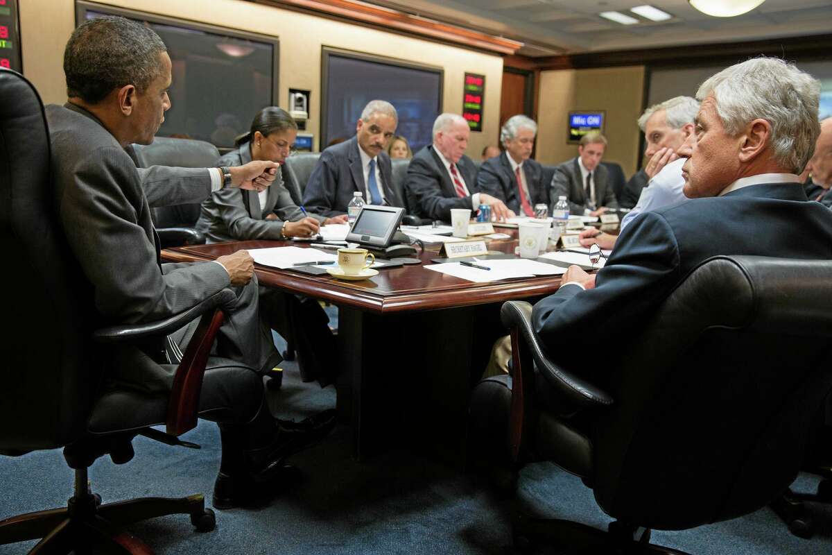 In this July 3, 2013, photo provided by the White House, President Barack Obama, left, meets with members of his national security team to discuss the situation in Egypt in the Situation Room of the White House in Washington.