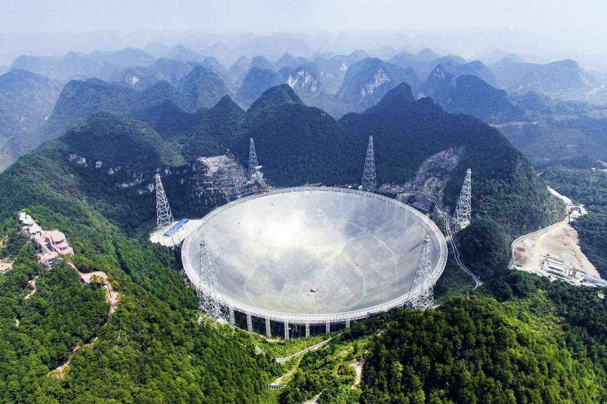 In this Sept. 24, 2016 photo released by Xinhua News Agency, an aerial view shows the Five-hundred-meter Aperture Spherical Telescope (FAST) in the remote Pingtang county in southwest China’s Guizhou province. China has begun operating the world’s largest radio telescope to help search for extraterrestrial life.