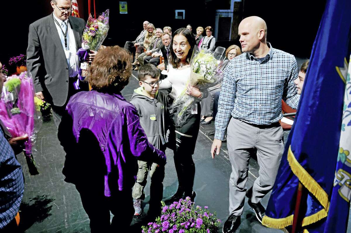 Connecticut Teacher of the Year Lauren Danner, center, is given bouquets of flowers by her family during an assembly in her honor at North Branford High School Tuesday.
