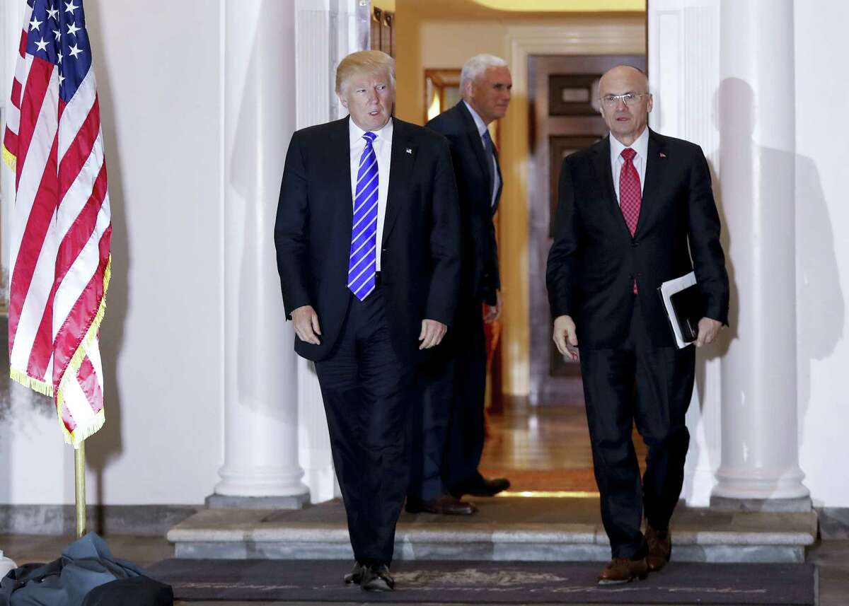 In this Nov. 19 file photo, President-elect Donald Trump walks Labor Secretary-designate Andy Puzder from Trump National Golf Club Bedminster clubhouse in Bedminster, N.J. Propelled by populist energy, President-elect Donald Trump’s candidacy broke long-standing conventions and his incoming Cabinet embodies a sharp turn from the outgoing Obama administration.