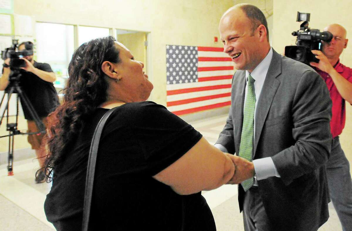 Peter Hvizdak — Register Garth Harries, newly appointed City of New Haven Superintendent of Schools, right, is congratulated by East Rock School PTO President and Citywide Parent Leadership Team member Daisy Y. Gonzales Thursday July 25, 2013 at the Fair Haven School in New Haven.