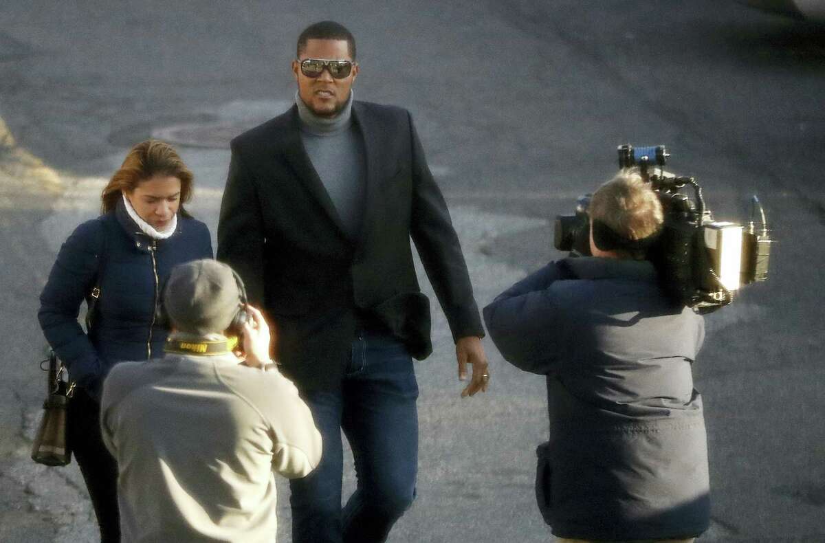 News photographers aim their cameras at New York Mets baseball pitcher Jeurys Familia, center, and his wife Bianca Rivas as they arrive at the Fort Lee Municipal Court prior to a hearing on Dec. 15, 2016 in Fort Lee, N.J. Domestic abuse charges were dropped against Familia, who appeared in court for a case involving an incident with with Rivas on Oct. 31, 2016.