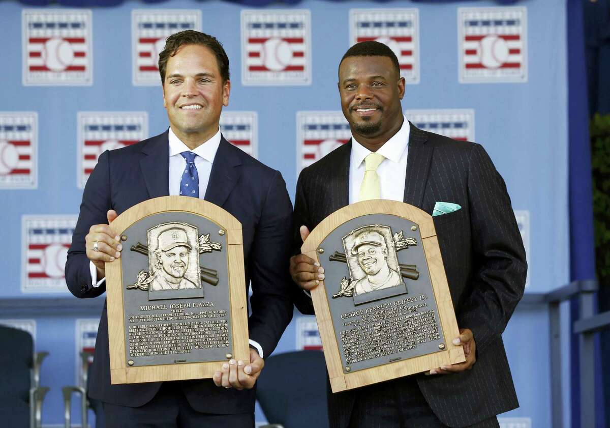 National Baseball Hall of Fame inductees Mike Piazza, left, and Ken Griffey Jr. hold their plaques after an induction ceremony on Sunday in Cooperstown, N.Y.