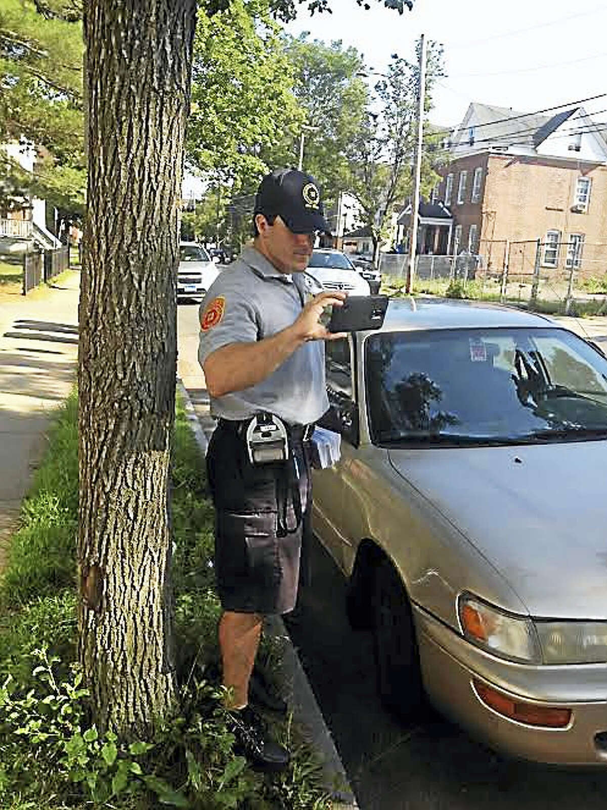 MARY O'LEARY - NEW HAVEN REGISTERParking enforcement officer Stephen Saladino tickets someone parked in a residential zone without a permit.