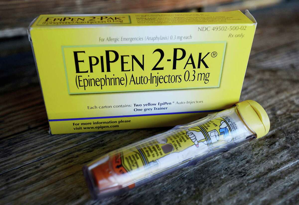 This Oct. 10, 2013 photo, shows an EpiPen epinephrine auto-injector, a Mylan product, in Hendersonville, Texas. Mylan, now in the crosshairs over severe price hikes for its EpiPen, said Thursday, Aug. 25, 2016, it will expand programs that lower out-of-pocket costs by as much as half.