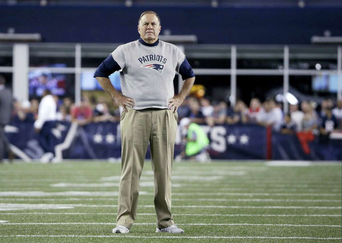 New England Patriots head coach Bill Belichick stands on the field