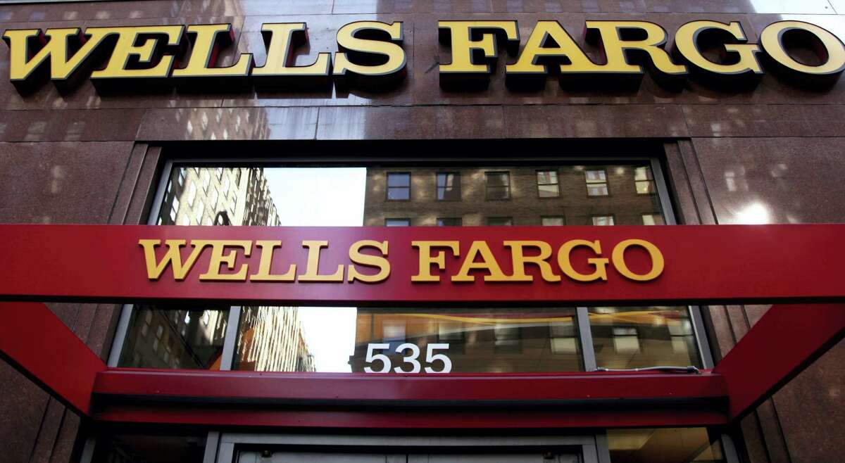In this file photo, a Wells Fargo sign is displayed at a branch in New York.