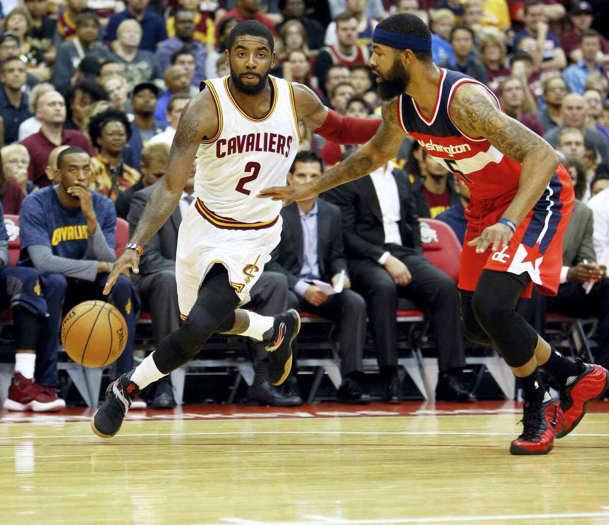 In this Oct. 18, 2016 photo, Cleveland Cavaliers’ Kyrie Irving, left, drives past Washington Wizards’ Markieff Morris during an NBA preseason basketball game in Columbus, Ohio. Cleveland’s Big 3 — LeBron James, Kevin Love and Irving — have finally meshed after two turbulent, strange seasons when the trio of All-Stars were often disconnected. But whatever kept them from uniting seems to be resolved and they’re determined to add to their legacy.