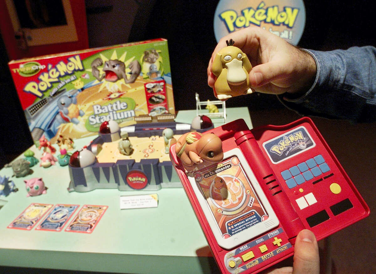 A Hasbro employee shows off components of the Pokemon Battle Stadium at the company’s showroom in New York.