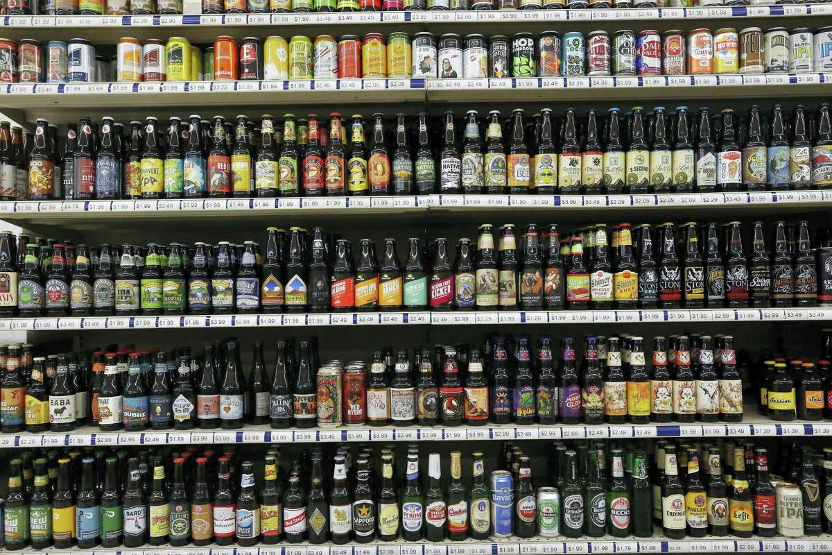 In this file photo, a shelf is stocked high with hundreds of varieties of single beers at Liquor Mart in Boulder, Colo. The Beer Institute says it is encouraging its members to start displaying more product information on labels, packaging and websites in a push to provide consumers with more details about ingredients, calories and other nutritional facts about their beverages.