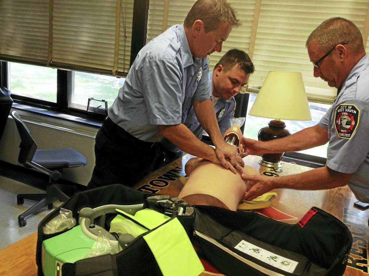 City of West Haven Fire Department — Allingtown paramedic Chris Shore, left, paramedic Paul Martus, center, and EMT Mike DiMassa demonstrate how to use the Lucas 2 chest compression system.