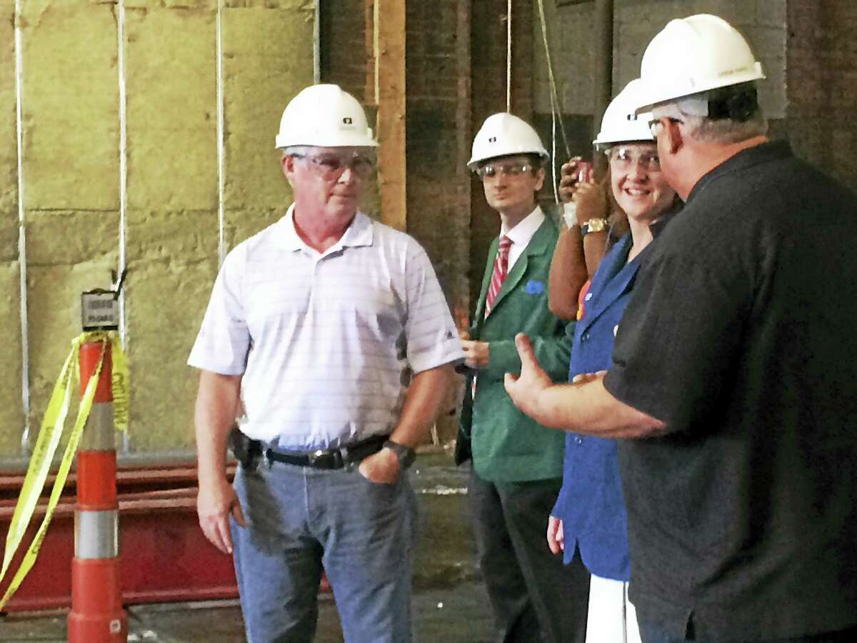 U.S. Rep. Elizabeth Esty listens as Consolidated Industries General Manager Drew Papio, right, discusses the company’s renovations to its Mixville Road plant. Looking on is the company’s President and CEO John Wilbur, left.