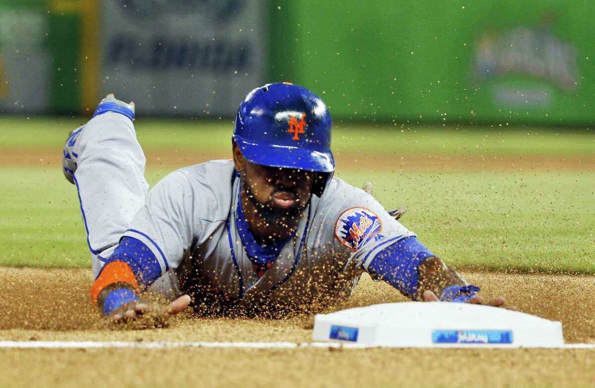 Jose Reyes slides as he steals third base during the first inning against the Marlins on Friday.
