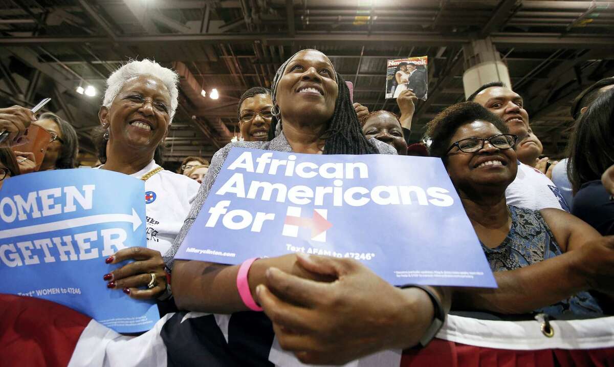 Supporters listen to first lady Michelle Obama as she speaks during a campaign rally for Democratic presidential candidate Hillary Clinton on Oct. 20, 2016 in Phoenix.