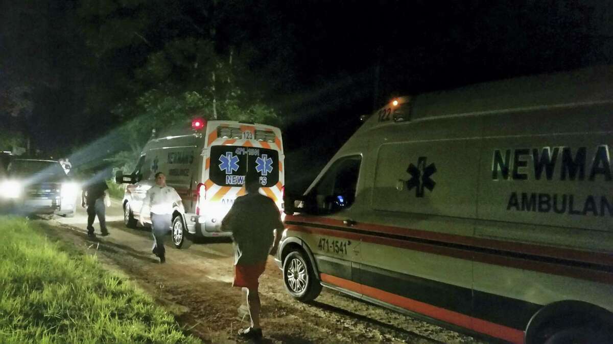 Ambulances wait along Jim Platt Road west of Citronelle, Ala., joining a stream of law enforcement vehicles at the scene of multiple homicides on Saturday, Aug. 20, 2016. The suspect in the killing of multiple people at a home in Alabama attacked them while they slept and then abducted his estranged girlfriend and an infant, both of whom were found alive, authorities said Sunday.