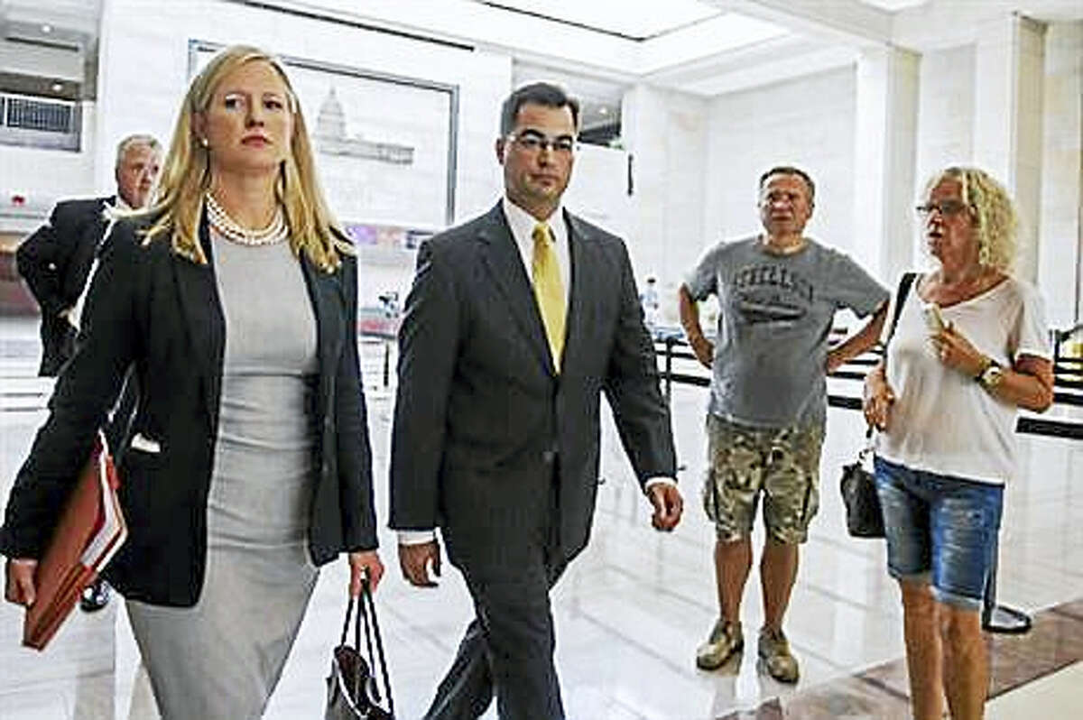 In this Sept. 10, 2015, file photo, Bryan Pagliano, center, a former State Department employee who helped set up and maintain a private email server used by Hillary Rodham Clinton, departs Capitol Hill in Washington. House Republicans on Tuesday, Sept. 13, 2016, continue their attacks on former Secretary of State Clinton’s emails by calling the tech expert who set up her private server and representatives from the company that maintained the system to testify at a congressional hearing. Pagliano, a former information resource management adviser at the State Department, is scheduled to appear Tuesday before the Oversight and Government Reform Committee.