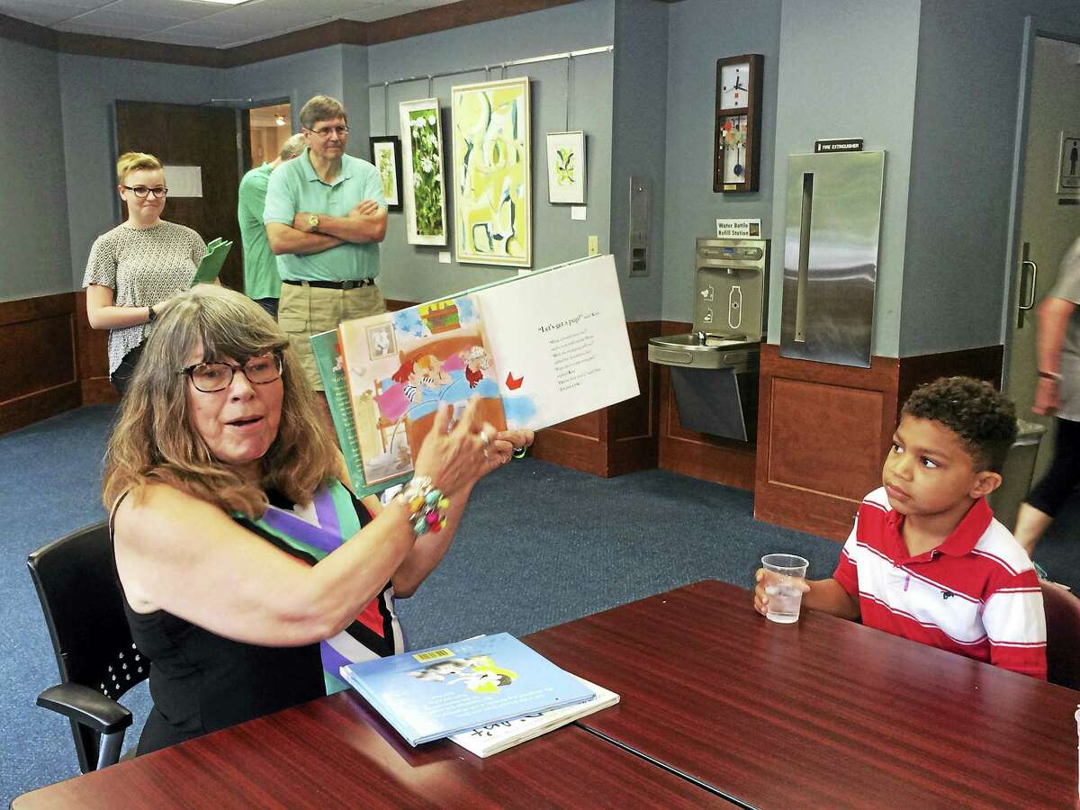 Lynn Rollo Hidek, Families Helping Families volunteer and a retired children’s librarian reads the children stories every Friday.