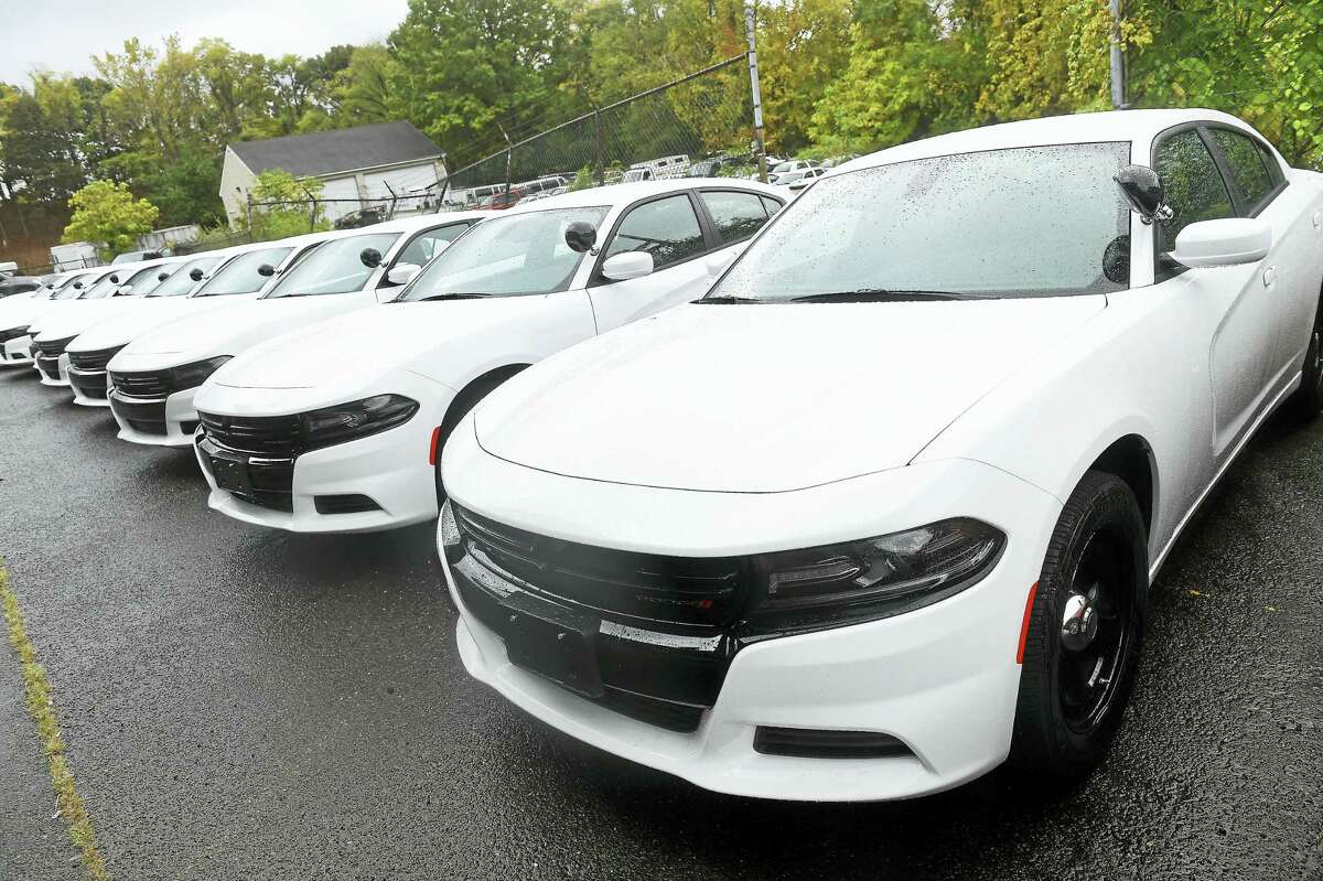 Arnold Gold-New Haven Register Thirteen new Dodge Chargers wait to be customized as patrol cars at the New Haven Police Department Maintenance Facility on 10/21/2016. Three more will be delivered.