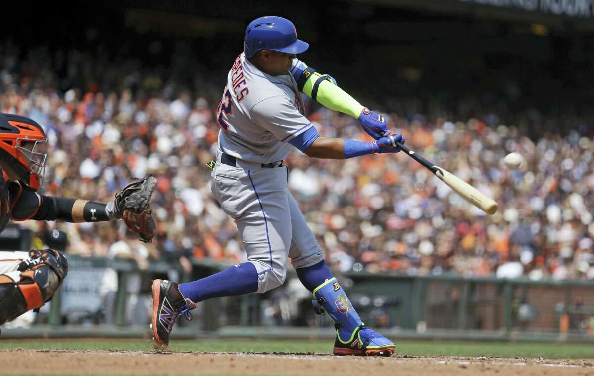 New York Mets’ Yoenis Cespedes connects for a home run off San Francisco Giants pitcher Matt Moore in the third inning of a baseball game Saturday in San Francisco.