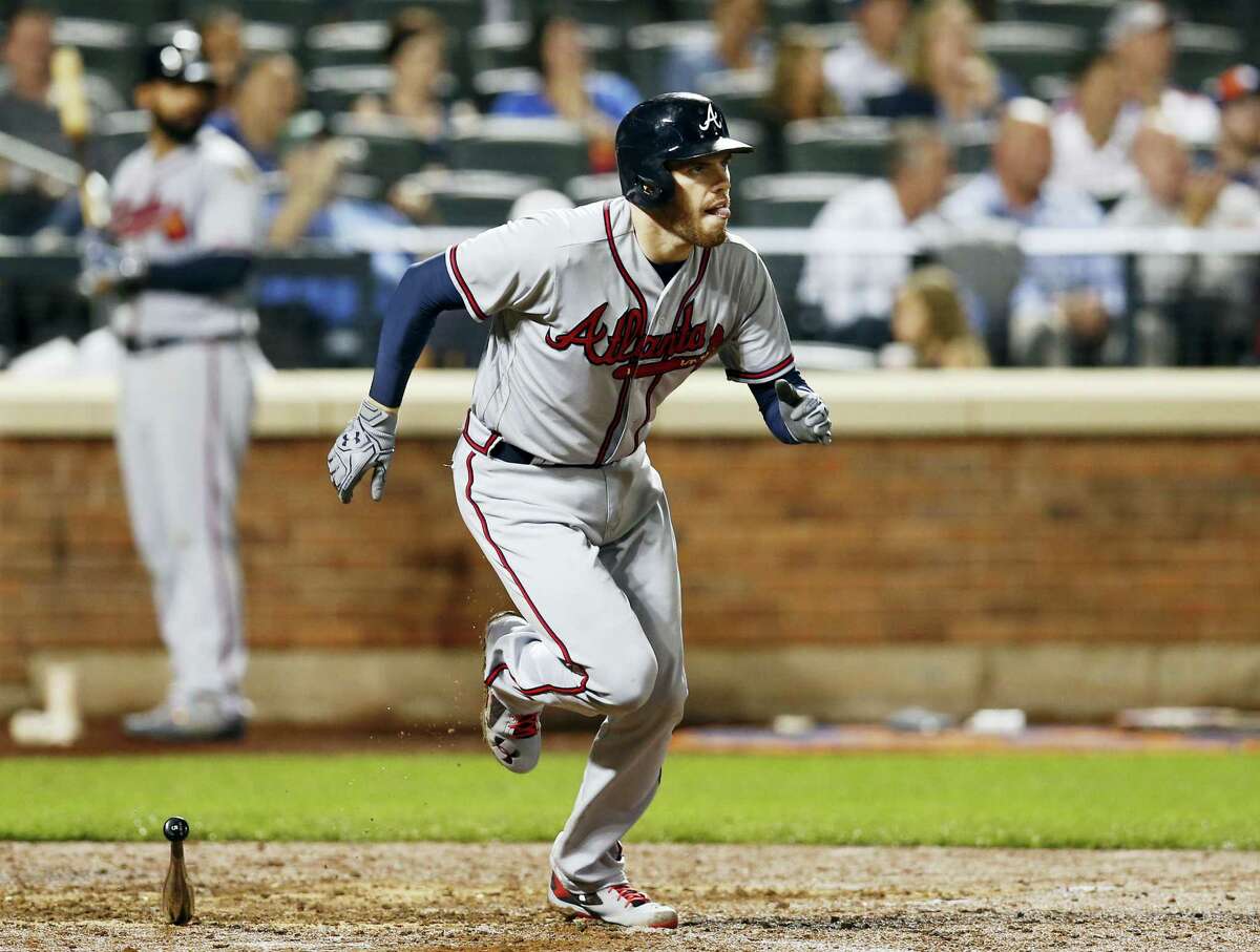 Atlanta Braves’ Freddie Freeman (5) runs on his eighth-inning, single hit during a baseball game against the New York Mets on Sept. 19, 2016 in New York. Freeman had a first inning solo home run, a fourth-inning, two-run double and a seventh-inning, infield single.