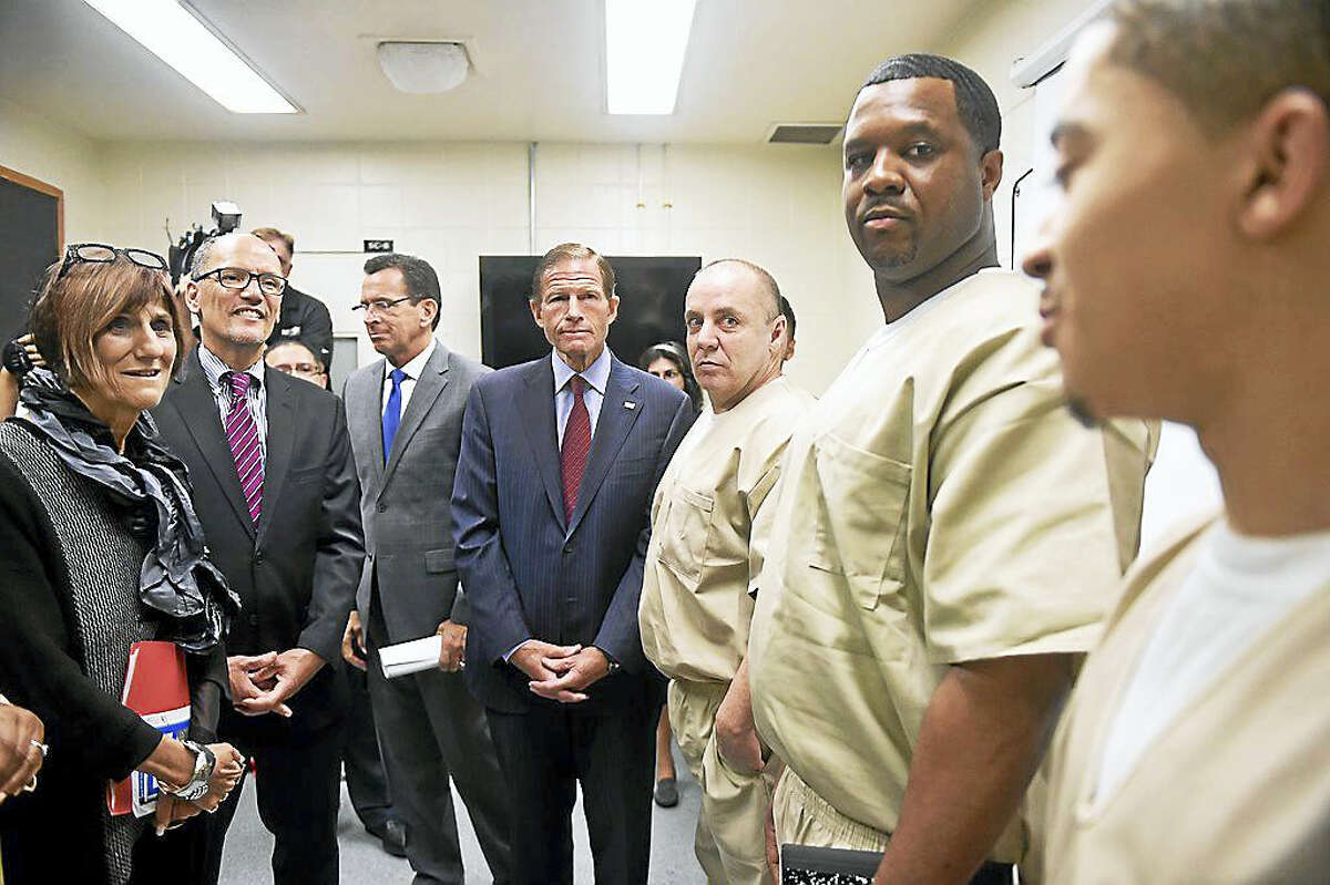 U.S. Secretary of Labor Thomas Perez joined other state and local politicians and officials Tuesday to visit the New Haven Community Correctional Center meeting with inmates involved with job training programs.