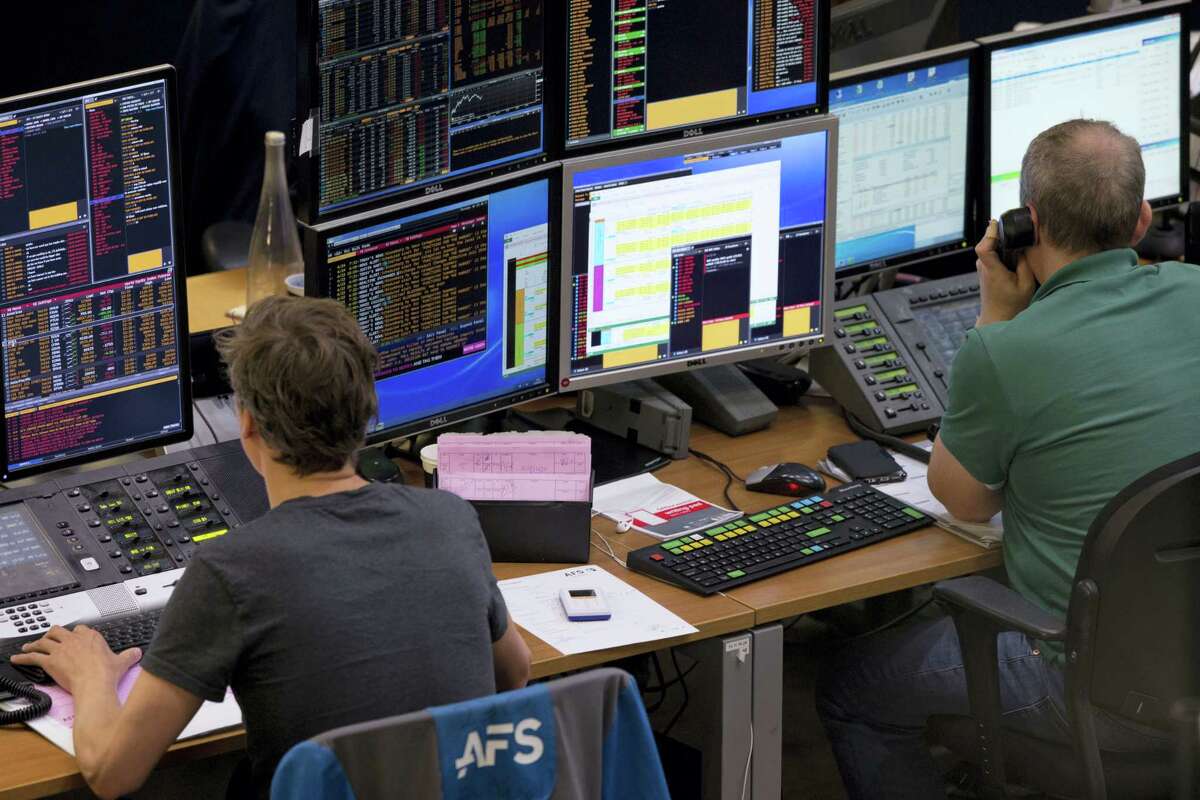 Two traders look at their screens as stocks plummeted following the British Brexit vote at the Euronext Amsterdam Stock Exchange, Netherlands on June 24, 2016. The British vote to leave the EU shook up financial markets around the globe on Monday, leading to sharp falls in stocks and the British pound.