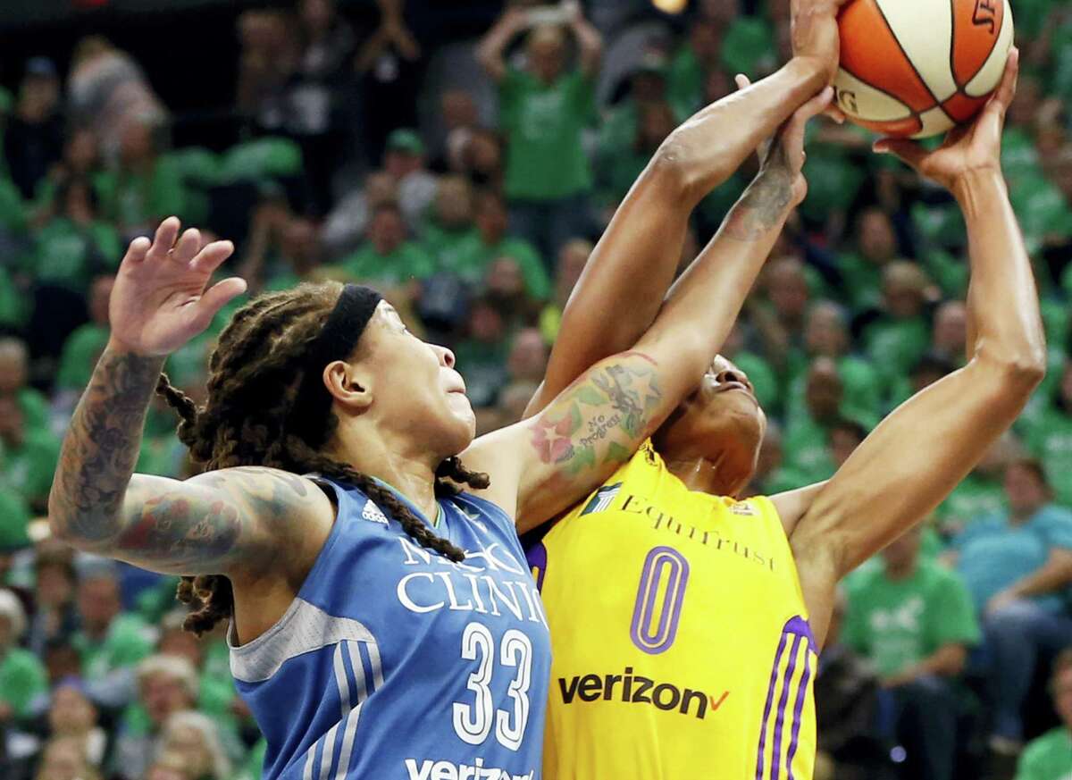 Minnesota Lynx’s Seimone Augustus, left, disrupts a shot attempt by Los Angeles Sparks’ Alana Beard in the first quarter during Game 5 of the WNBA basketball finals Thursday in Minneapolis. The Sparks dethroned the Lynx 77-76.