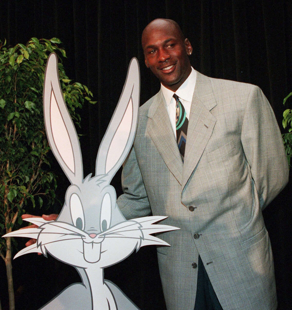In this undated 1995 photo, Michael Jordan is seen with cartoon character Bugs Bunny during a news conference for “Space Jam.” Fathom Events and Waner Bros. say the film that combines live action and animation will return to theaters on Nov. 13, 2016 to mark the 20th anniversary of its release.
