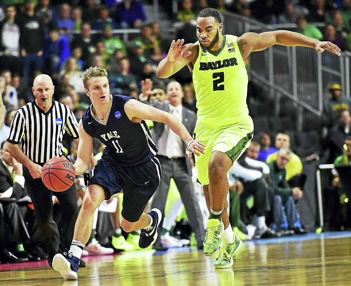 Yale’s Makai Mason takes off on a fastbreak as Baylor’s Rico Gathers defends in the final seconds of a 79-75 victory for the Bulldogs in the first round of the 2016 NCAA Men’s Basketball Tournament at the Dunkin’ Donuts Center in Providence, RI. (Catherine Avalone/New Haven Register)