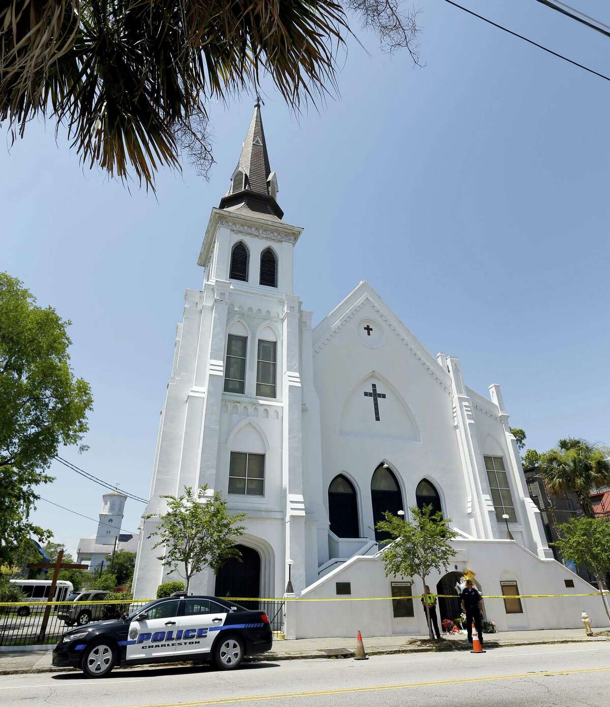 In this June 18, 2015, file photo, two Charleston police officers stand in front of the Emanuel AME Church in Charleston, S.C. The trial for Dylann Roof, a white man accused of killing nine black people at the church, started Wednesday, Dec. 7, 2016, at the federal courthouse in Charleston, SC.