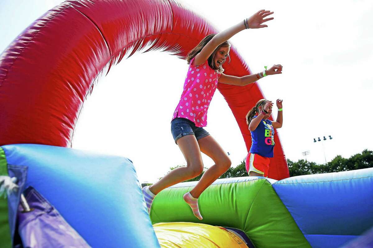 Children enjoy a bounce area at the 2015 Connecticut Open at the Yale University Tennis Center.