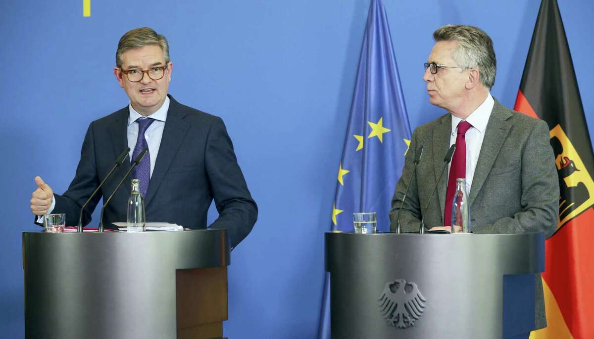 German Interior Minister Thomas de Maiziere, right, and British EU security commissioner Julian King answer journalists’ questions after their meeting in Berlin, Germany, Tuesday Oct. 18, 2016.