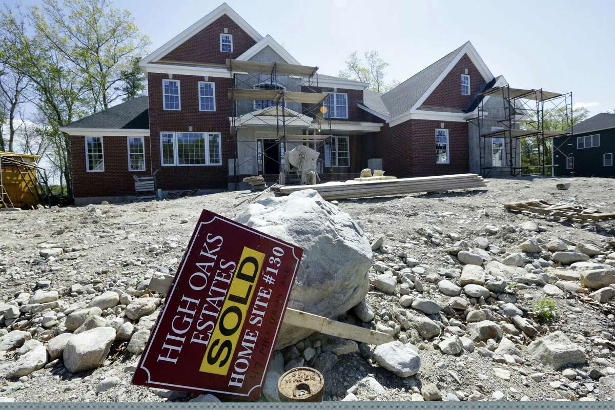 In this May 18, 2016 photo, a “Sold” sign rests in front of a house under construction, in Walpole, Mass. On Oct. 18, 2016, the National Association of Home Builders/Wells Fargo releases its October index of builder sentiment.