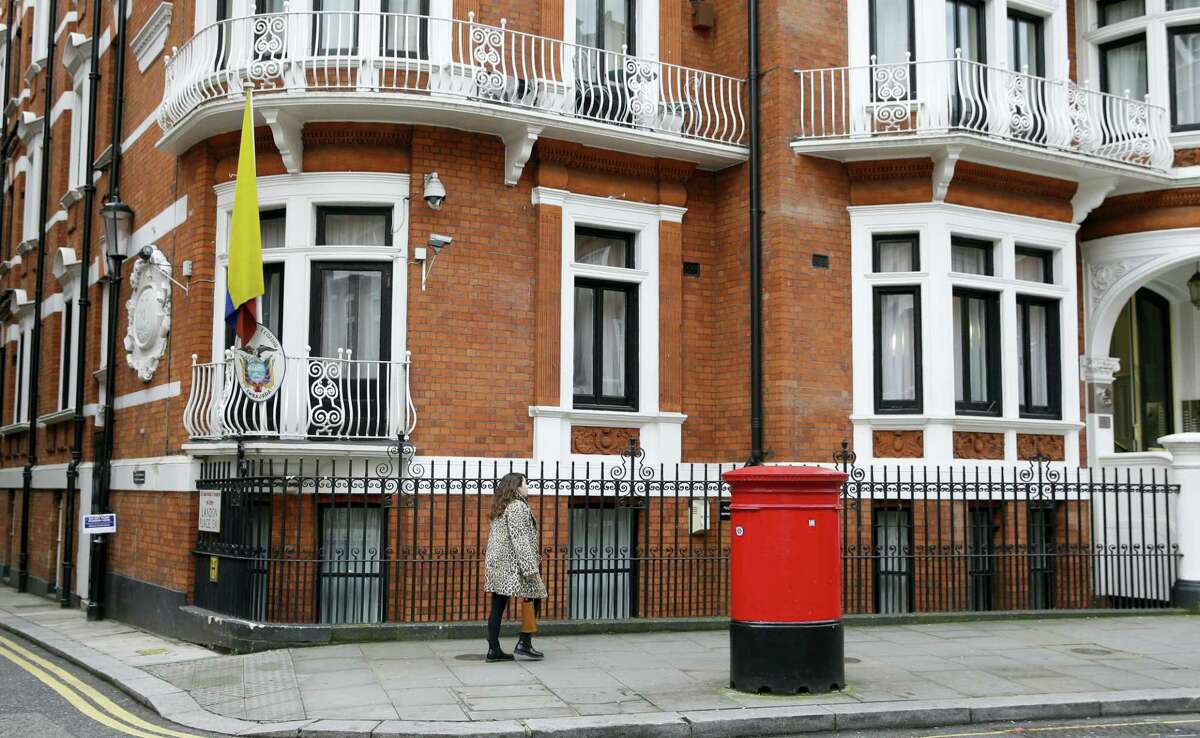 A woman walks past the Ecuadorian Embassy in London, Tuesday, Oct. 18, 2016. Midway through releasing a series of damaging disclosures about U.S. presidential contender Hillary Clinton, WikiLeaks founder Julian Assange says his hosts at the Ecuadorean Embassy in London abruptly cut him off from the internet. The news adds another layer of intrigue to an extraordinary campaign.