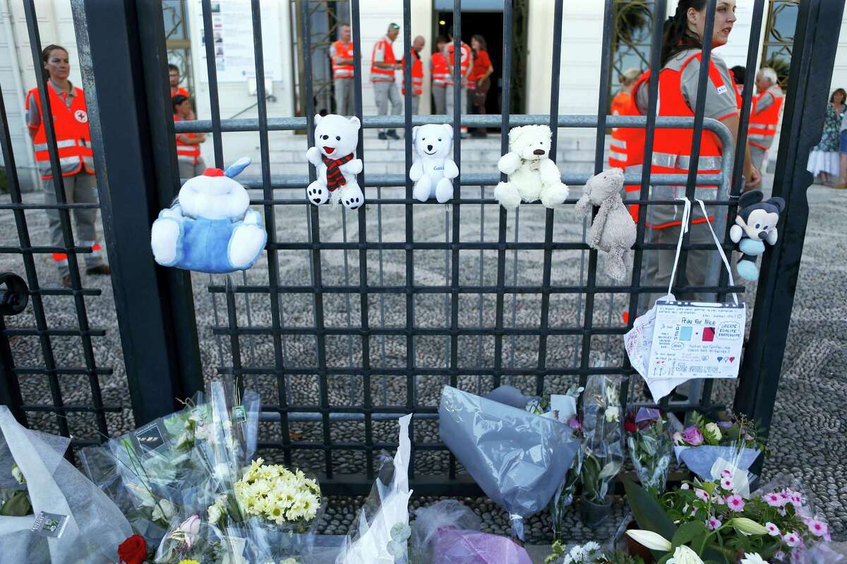 Teddy bears and flowers are placed in tribute of the victims of the deadly truck attack in front of a temporary emergency centre on the famed Promenade des Anglais in Nice, southern France, Saturday, July 16, 2016. French Interior Minister Bernard Cazeneuve says that the truck driver who killed 84 people when he careened into a crowd at a fireworks show was “radicalized very quickly.”