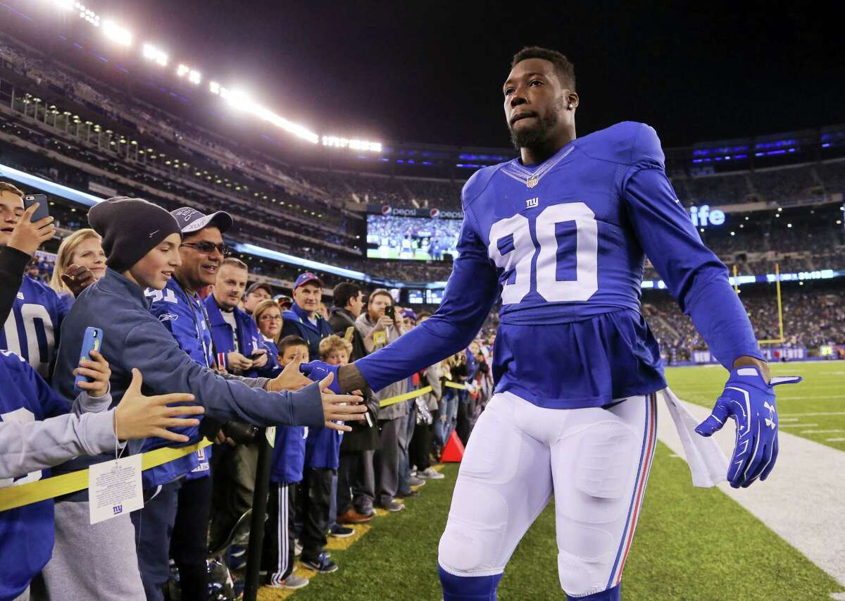 In this Nov. 14 file photo, New York Giants defensive end Jason Pierre-Paul greets fans before an NFL football game against the Cincinnati Bengals in East Rutherford, N.J. Pierre-Paul is going to miss the rest of the regular season after surgery to repair a sports hernia. The 27-year-old old tweeted on Wednesday that he had surgery and was feeling well.