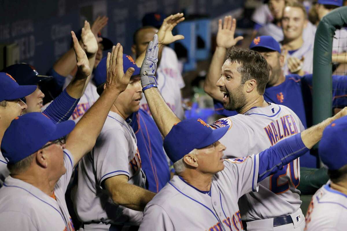Neil Walker, right, celebrates with teammates after hitting a three-run home run during the sixth inning on Friday.